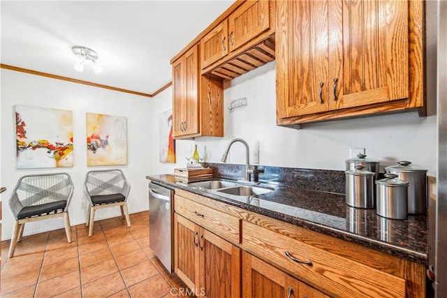 kitchen featuring dark stone counters, a sink, brown cabinets, dishwasher, and crown molding