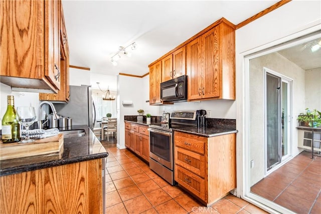 kitchen with brown cabinetry, electric stove, black microwave, a sink, and light tile patterned flooring