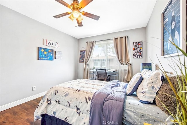 bedroom with ceiling fan, baseboards, and wood finished floors