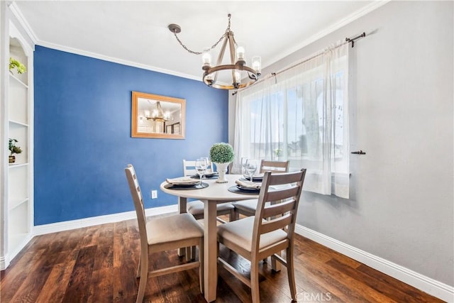 dining room featuring ornamental molding, a notable chandelier, baseboards, and wood finished floors