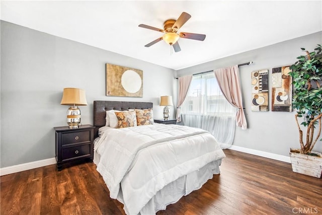 bedroom featuring ceiling fan, baseboards, and wood finished floors