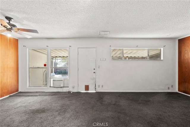 entryway with ceiling fan, carpet flooring, visible vents, and a textured ceiling