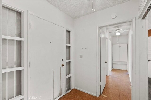 corridor featuring a textured ceiling