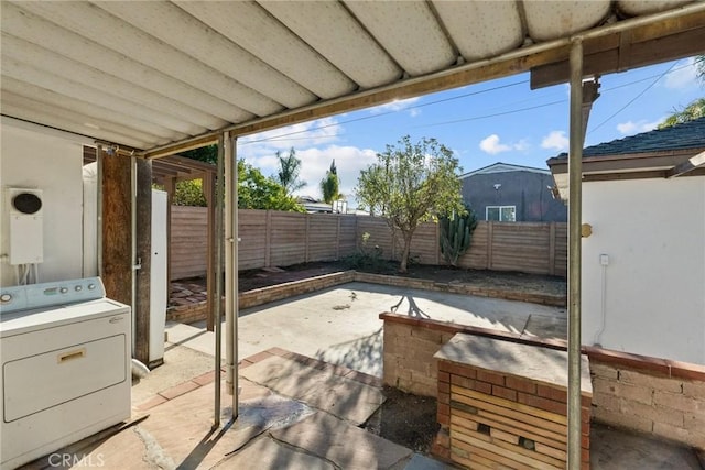 view of patio / terrace featuring washer / dryer and a fenced backyard