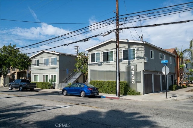 multi unit property with stairs and stucco siding