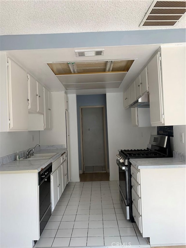 kitchen featuring visible vents, dishwasher, light countertops, under cabinet range hood, and stainless steel range with gas stovetop