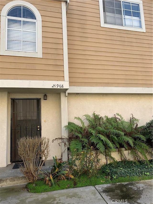 doorway to property with stucco siding