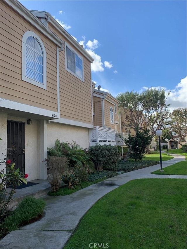 view of front of property with a front lawn and stucco siding