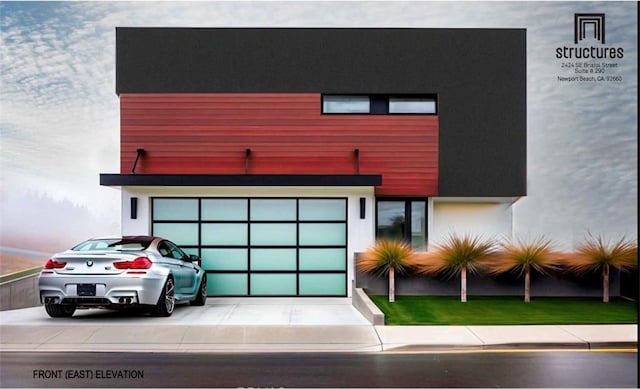 view of front of property with driveway, an attached garage, and stucco siding