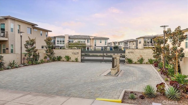 view of property's community with a gate, fence, and a residential view