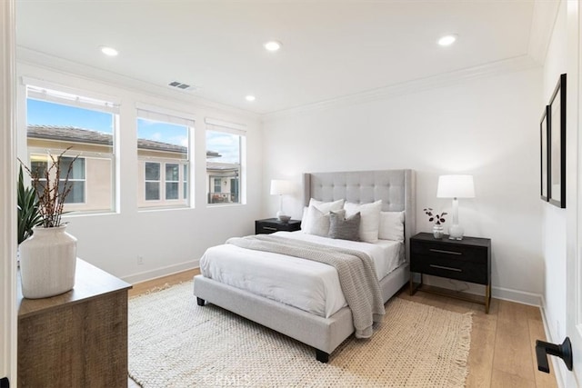 bedroom featuring crown molding, recessed lighting, baseboards, and light wood-type flooring