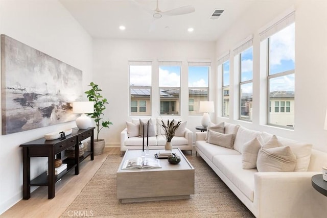 living area featuring visible vents, baseboards, ceiling fan, recessed lighting, and light wood-style floors