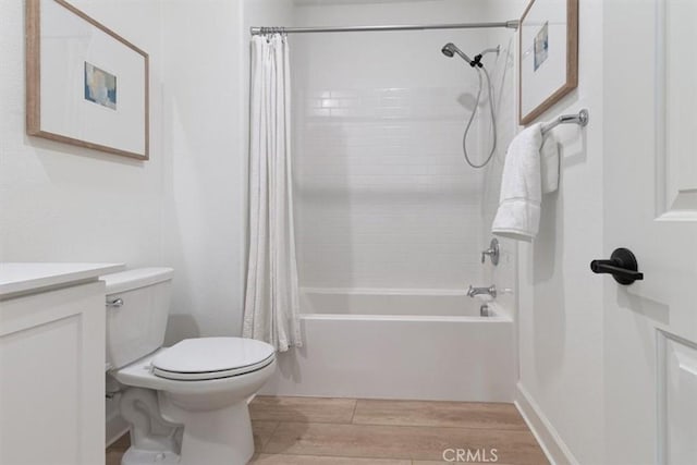 full bathroom featuring vanity, toilet, shower / tub combo with curtain, and wood finish floors