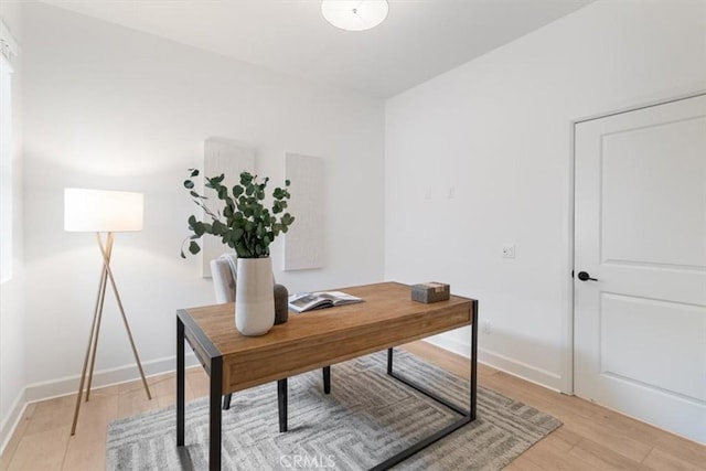 office area with light wood-style flooring and baseboards