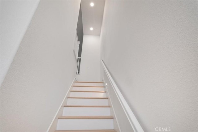 stairway featuring recessed lighting