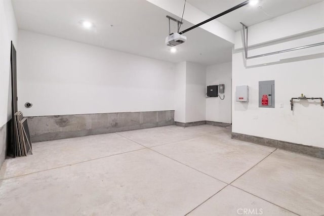 garage featuring electric panel and a garage door opener