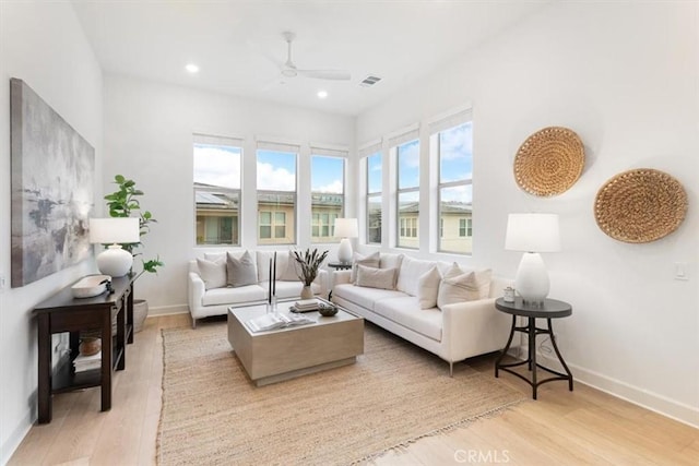 living room with visible vents, a healthy amount of sunlight, baseboards, and light wood-style floors