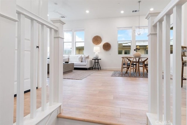 foyer entrance featuring recessed lighting, plenty of natural light, wood finished floors, and visible vents