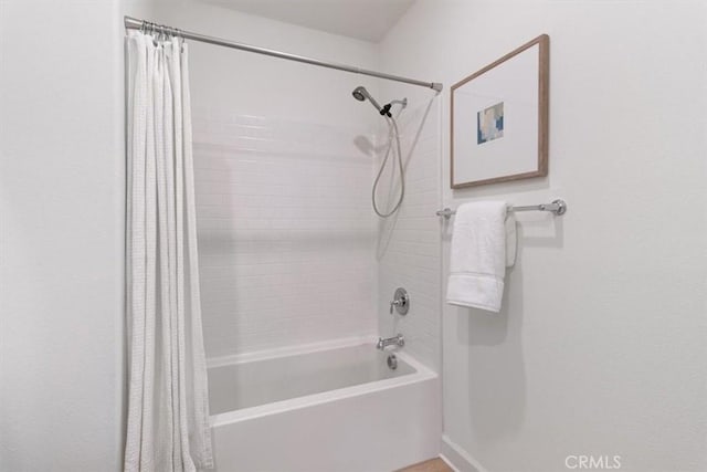 bathroom with shower / bathtub combination with curtain