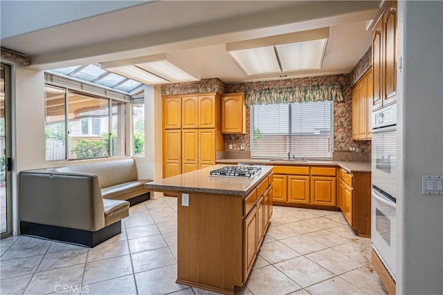 kitchen featuring a center island, backsplash, and a healthy amount of sunlight