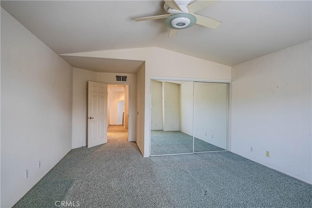 unfurnished bedroom with a ceiling fan, visible vents, a closet, lofted ceiling, and carpet flooring