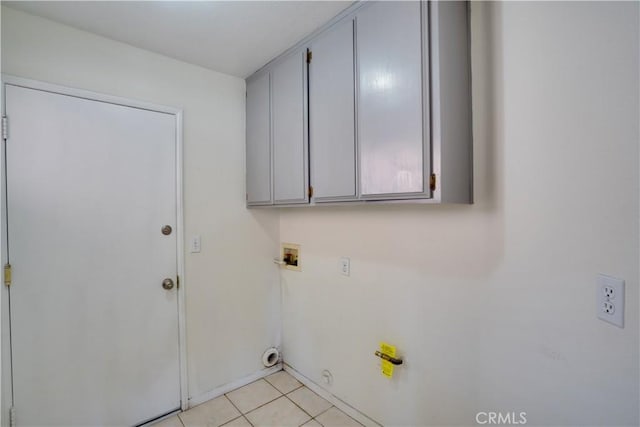 laundry room featuring cabinet space, light tile patterned floors, hookup for a gas dryer, and hookup for a washing machine