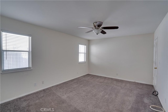 spare room featuring carpet flooring, ceiling fan, and baseboards