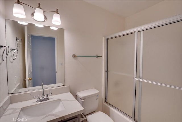 full bathroom with combined bath / shower with glass door, vanity, and toilet