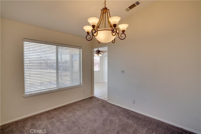 carpeted spare room with baseboards, visible vents, and a chandelier