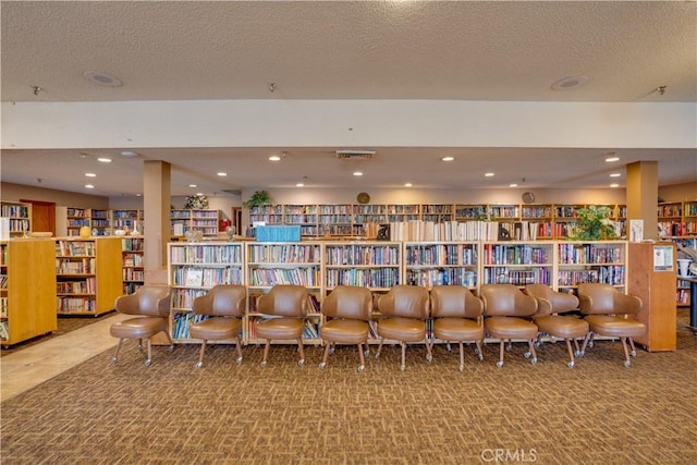 interior space with recessed lighting, visible vents, a textured ceiling, and carpet flooring