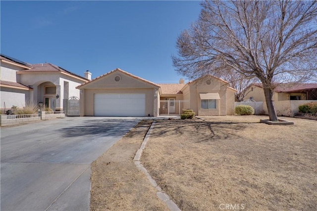 view of front of house with concrete driveway, fence, an attached garage, and stucco siding