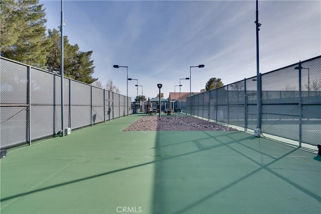 view of sport court featuring fence