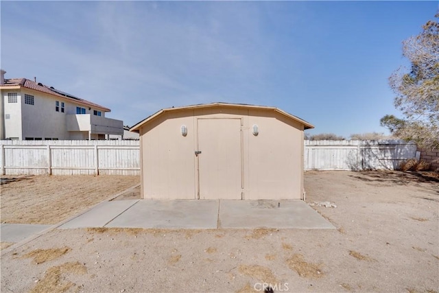 view of shed with a fenced backyard