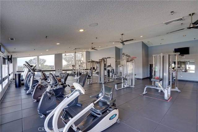 workout area with a textured ceiling, visible vents, and a wealth of natural light