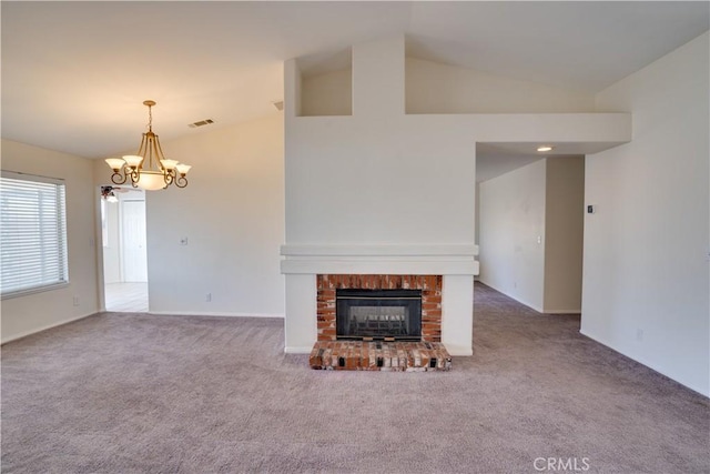 unfurnished living room featuring carpet floors, visible vents, a fireplace, and an inviting chandelier