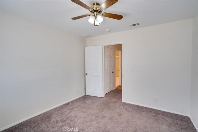 unfurnished room with a ceiling fan, carpet, visible vents, and baseboards