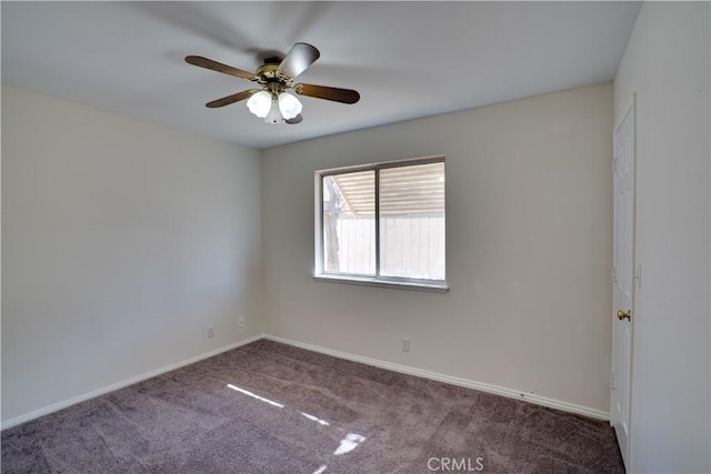 empty room with carpet floors, baseboards, and a ceiling fan