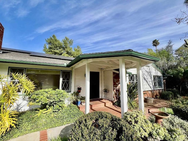 doorway to property featuring solar panels