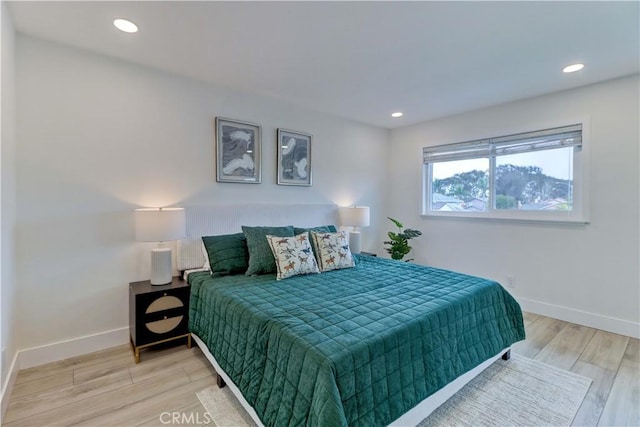 bedroom with baseboards, recessed lighting, and light wood-style floors