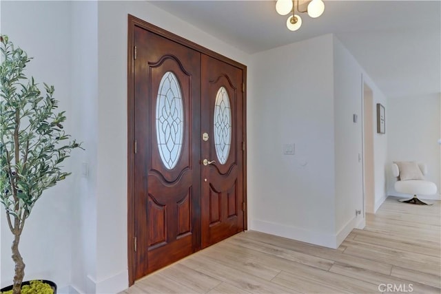 foyer featuring light wood-type flooring and baseboards