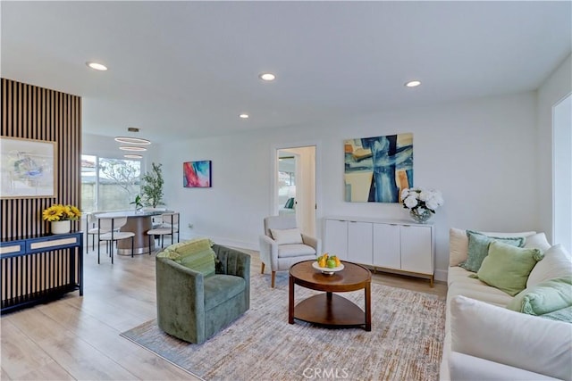 living area with light wood finished floors, baseboards, and recessed lighting