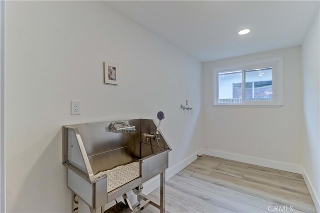 interior space featuring recessed lighting, wood finished floors, and baseboards