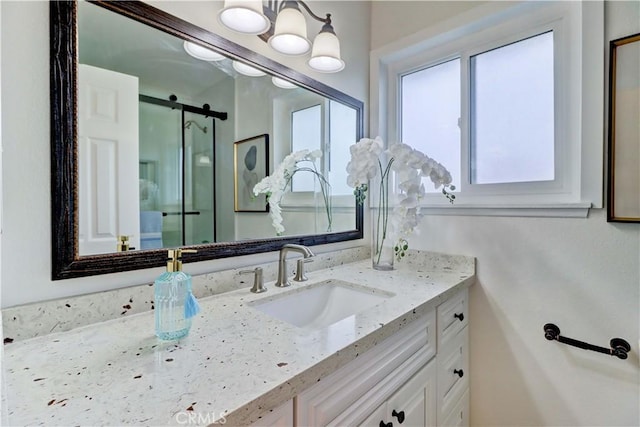 bathroom featuring a shower stall, a chandelier, and vanity