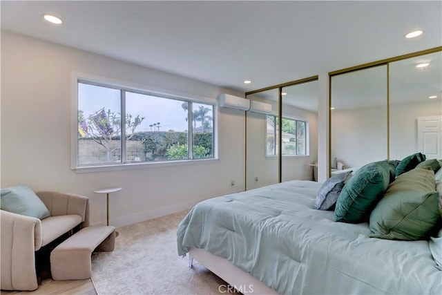 bedroom featuring baseboards, a wall unit AC, carpet flooring, multiple closets, and recessed lighting