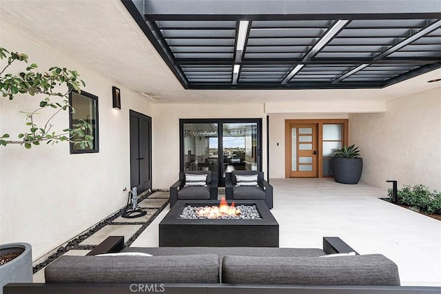 view of patio / terrace with french doors, an outdoor living space with a fire pit, and visible vents