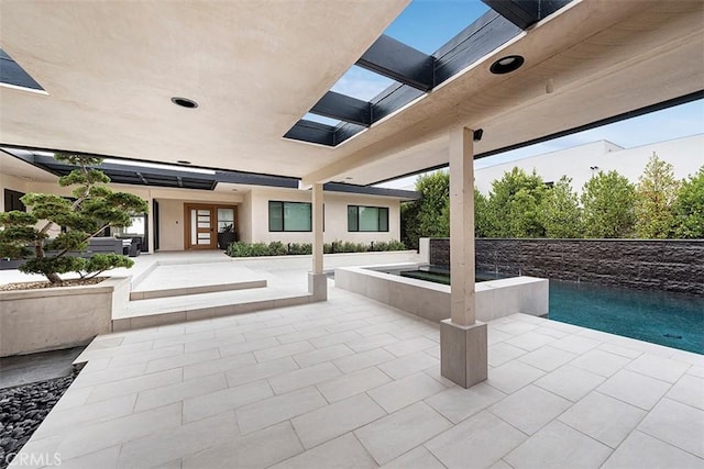 view of patio with an outdoor hot tub