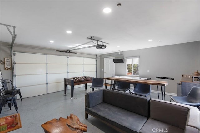 garage with a garage door opener and recessed lighting