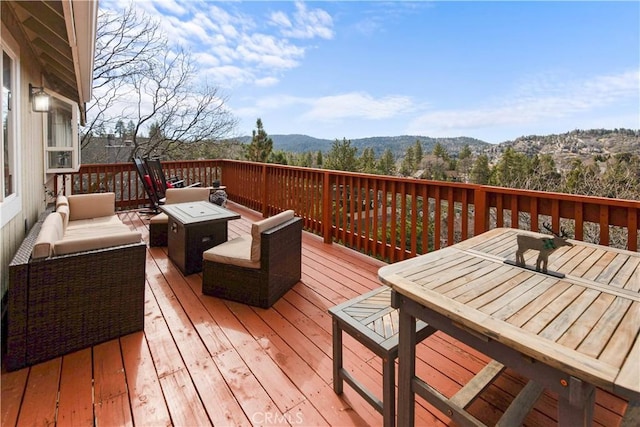 wooden deck featuring outdoor lounge area and a mountain view