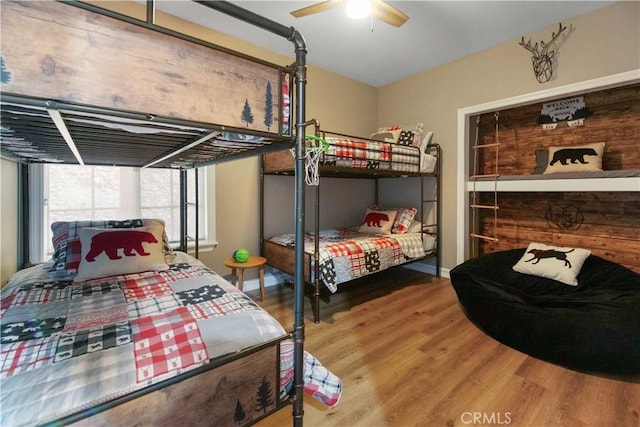 bedroom with ceiling fan and wood finished floors