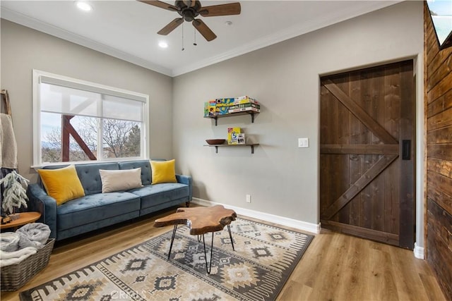 living room with ornamental molding, recessed lighting, baseboards, and wood finished floors